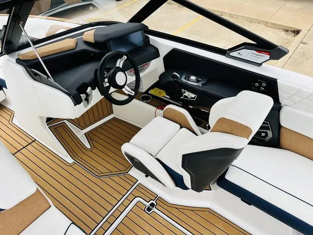 Slide: The Image of 2024 Nautique G23 boat interior with sleek design and modern dashboard. - 42