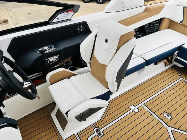 Slide: The Image of 2024 Nautique G23 boat interior with luxurious seating and modern dashboard design. - 43
