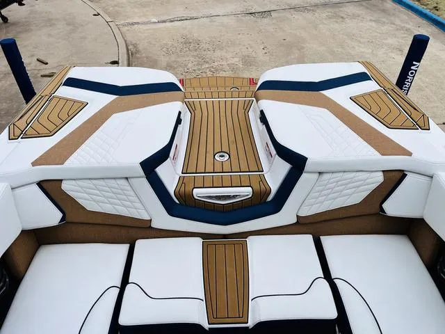 Slide: The Image of 2024 Nautique G23 boat interior with stylish white and tan upholstery. - 47