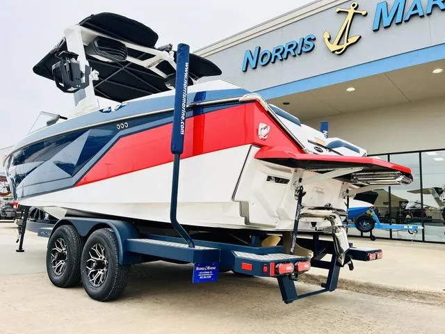 Slide: The Image of 2024 Nautique G23 boat in red, white, and blue at Norris Marine dealership. - 7