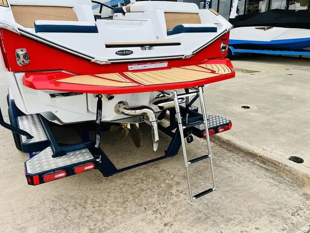 Slide: The Image of 2024 Nautique G23 boat rear view with swim platform and ladder. - 8