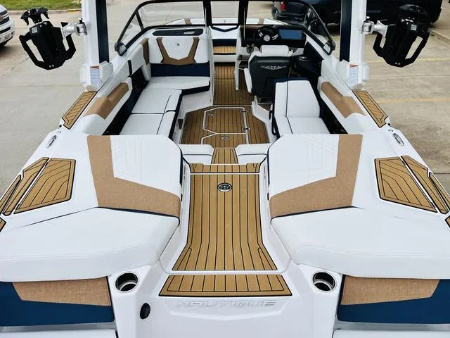 Slide: The Image of 2024 Nautique G23 boat interior with luxurious seating and modern design. - 10