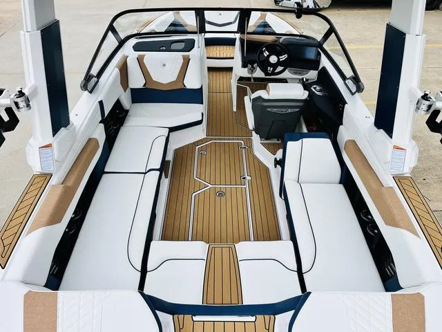 Slide: The Image of 2024 Nautique G23 boat interior with luxurious seating and modern dashboard design. - 11