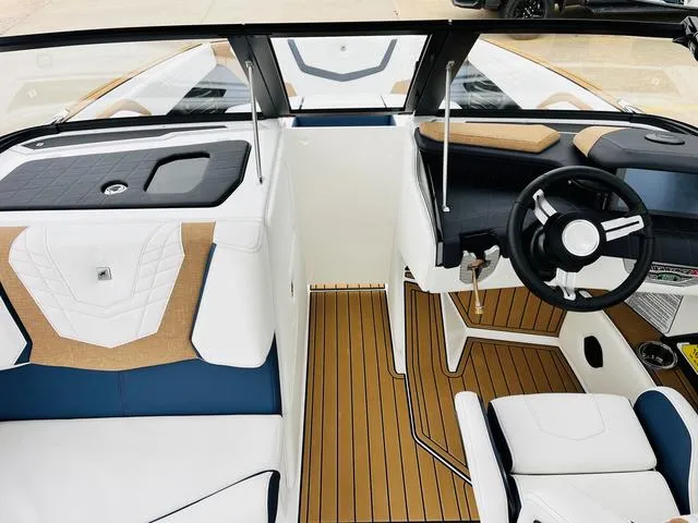 Slide: The Image of 2024 Nautique G23 boat interior with sleek design and modern dashboard. - 19