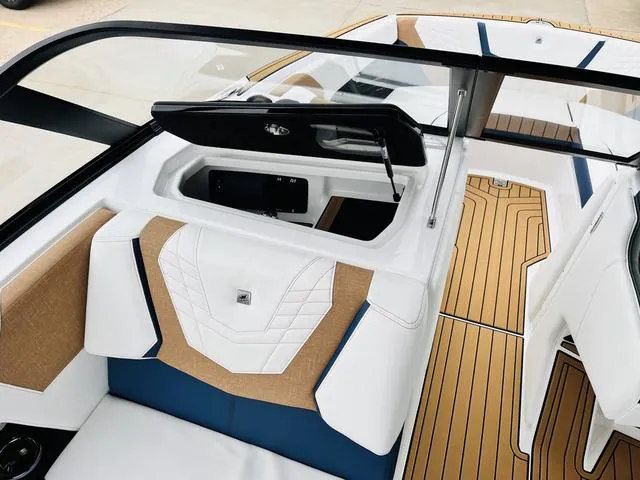 Slide: The Image of 2024 Nautique G23 boat interior with stylish seating and modern dashboard design. - 21