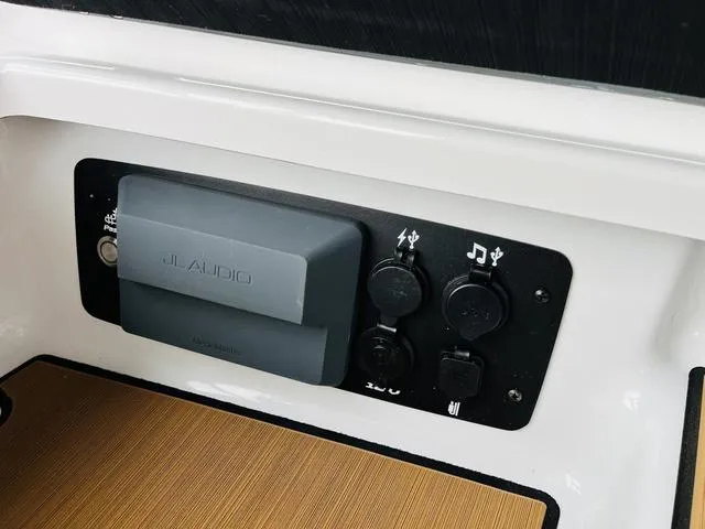 Slide: The Image of 2024 Nautique G23 JL Audio panel with charging ports and controls. - 22