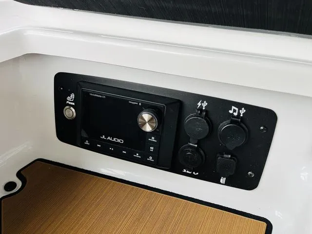 Slide: The Image of 2024 Nautique G23 audio control panel with JL Audio system. - 23