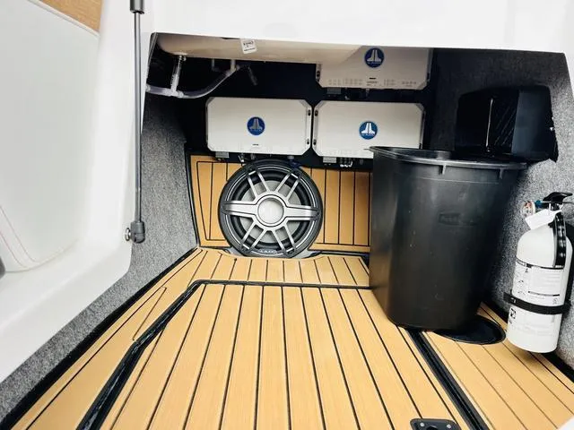 Slide: The Image of 2024 Nautique G23 boat interior with speaker, storage, and fire extinguisher. - 26