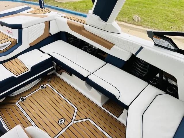 Slide: The Image of 2024 Nautique G23 boat interior with white and tan seating, luxury design. - 29