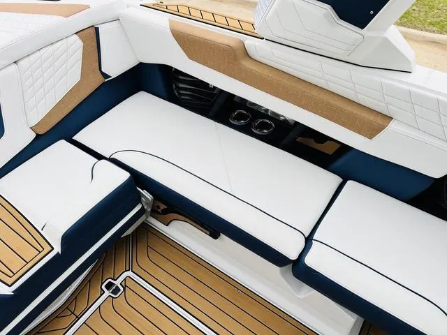 Slide: The Image of 2024 Nautique G23 interior with white and tan seating, featuring modern design and detailing. - 32
