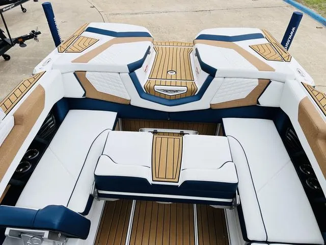 Slide: The Image of 2024 Nautique G23 boat interior with luxurious seating and teak flooring. - 35