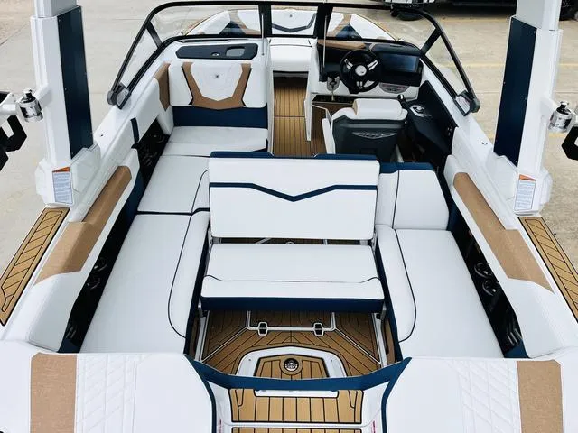Slide: The Image of 2024 Nautique G23 boat interior with white and tan seating, modern design, and spacious layout. - 37