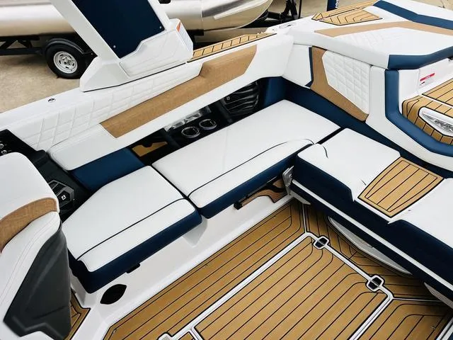 Slide: The Image of 2024 Nautique G23 boat interior with white and tan seating, stylish design. - 40