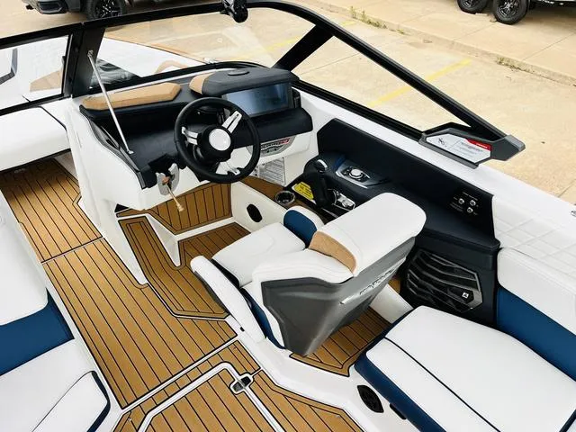 Slide: The Image of 2024 Nautique G23 boat interior with modern helm and luxurious seating. - 44
