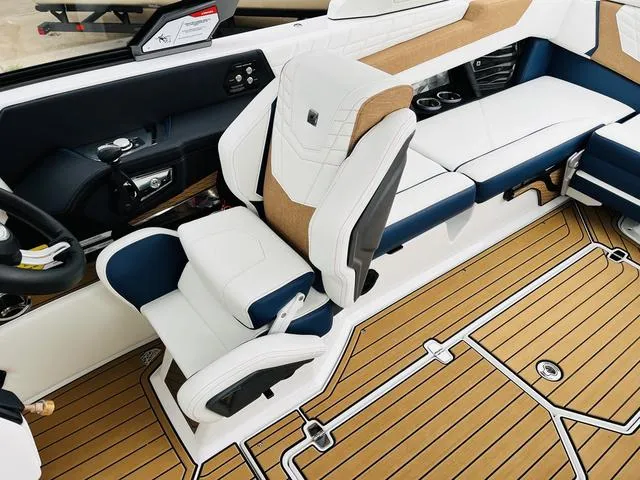 Slide: The Image of 2024 Nautique G23 boat interior with luxurious seating and teak flooring. - 46