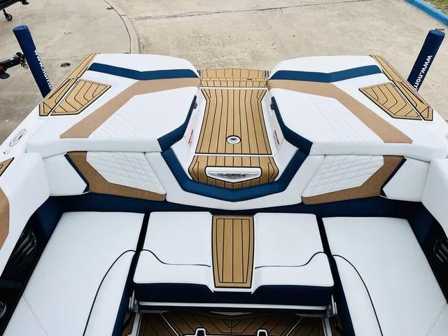 Slide: The Image of 2024 Nautique G23 boat interior with white and tan upholstery, featuring sleek design elements. - 48