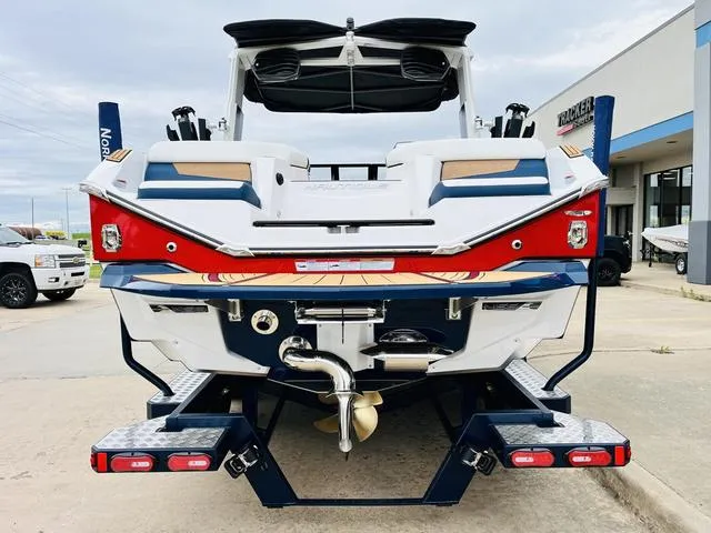 Slide: The Image of 2024 Nautique G23 boat rear view, showcasing sleek design and modern features. - 6