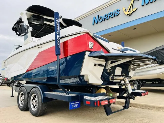 Slide: The Image of 2024 Nautique G23 boat on trailer at Norris Marine dealership. - 7