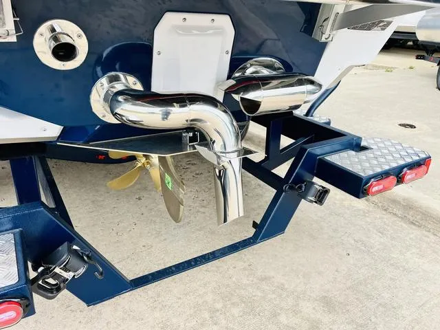 Slide: The Image of 2024 Nautique G23 boat stern with propeller and exhaust system. - 9