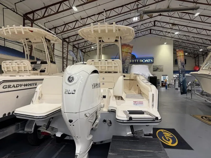 Slide: The Image of 2025 Grady-White Fisherman 216 boat in showroom, featuring Yamaha outboard motor. - 4