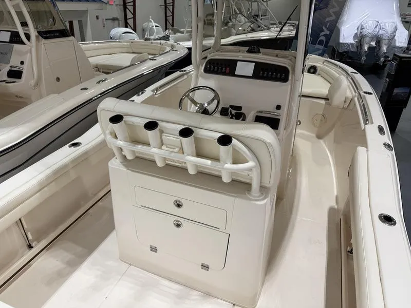 Slide: The Image of 2025 Grady-White Fisherman 216 boat interior with rod holders and steering console. - 5