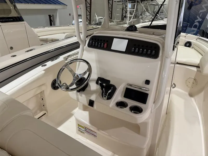 Slide: The Image of 2025 Grady-White Fisherman 216 boat interior with steering console and controls. - 6