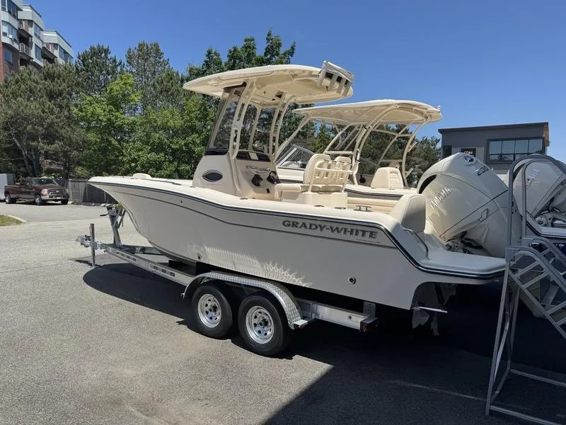 Slide: The Image of 2025 Grady-White Fisherman 216 boat on trailer, parked outdoors under clear sky. - 3