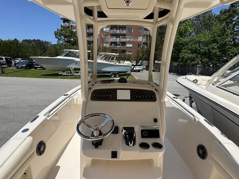 Slide: The Image of 2025 Grady-White Fisherman 216 boat cockpit with steering wheel and control panel. - 9