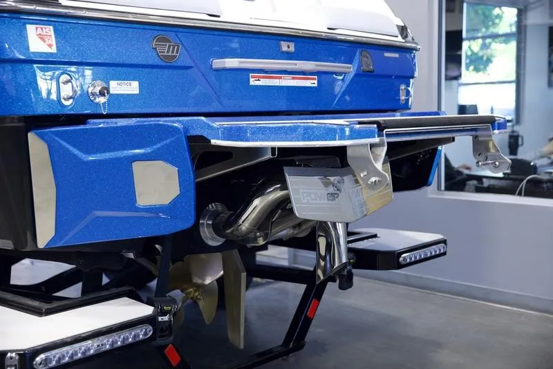 Slide: The Image of 2024 Malibu 23 LSV boat rear view, showcasing blue exterior and advanced features. - 2