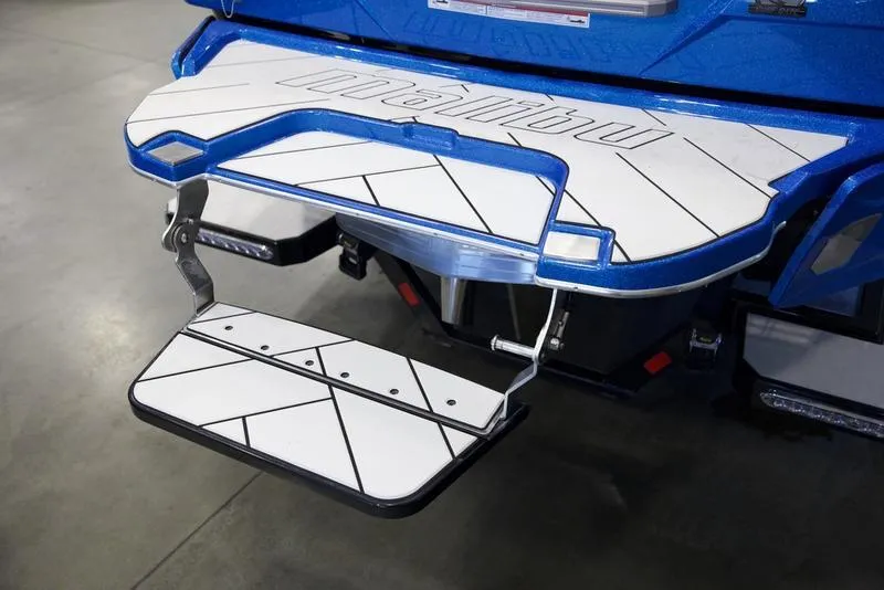 Slide: The Image of 2024 Malibu 23 LSV swim platform with step, featuring sleek blue and white design. - 7