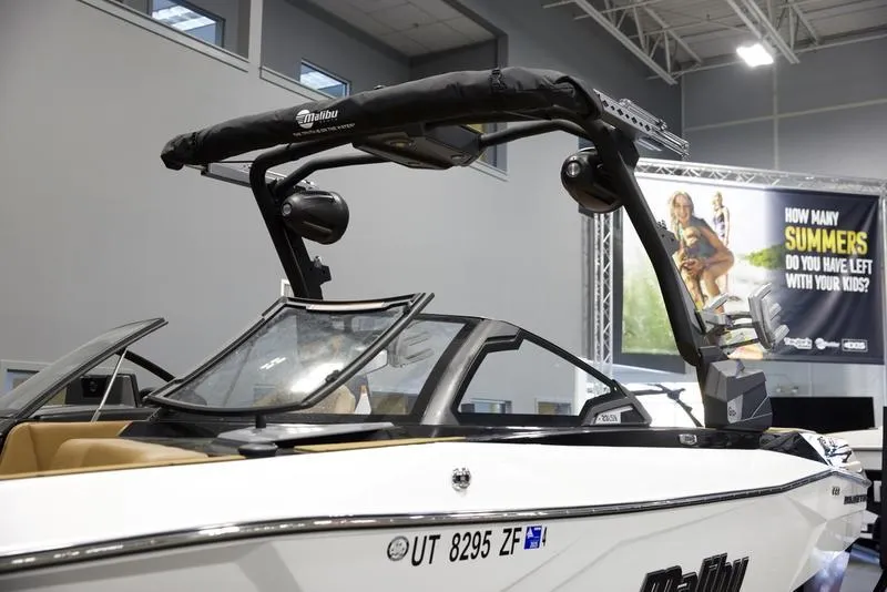 Slide: The Image of 2024 Malibu 23 LSV boat displayed indoors with sleek design and modern features. - 13