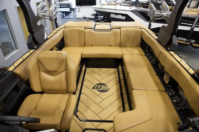 Slide: The Image of 2024 Malibu 23 LSV boat interior with tan leather seating and stylish design. - 14
