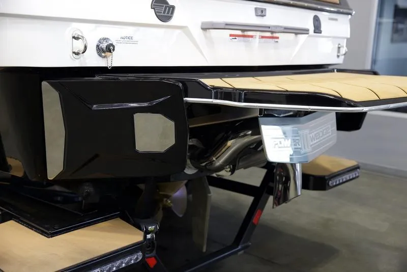 Slide: The Image of 2024 Malibu 23 LSV boat rear view with swim platform and exhaust system. - 16
