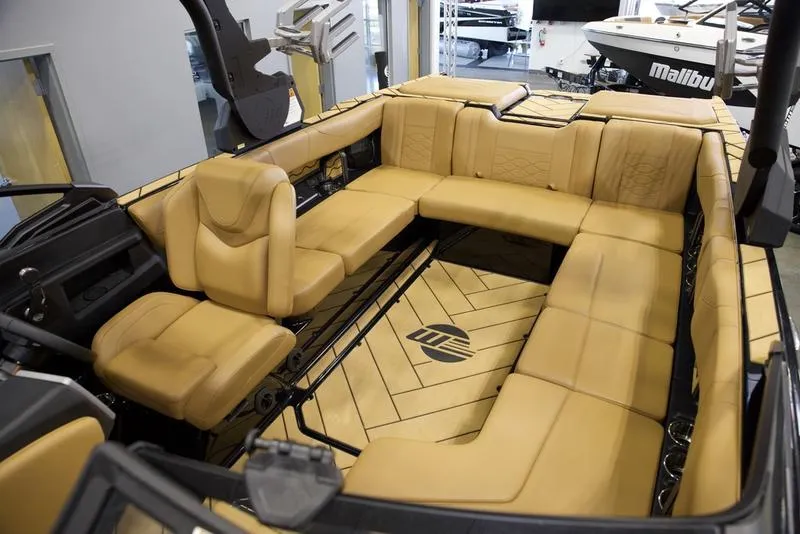 Slide: The Image of 2024 Malibu 23 LSV boat interior with luxurious tan seating. - 2