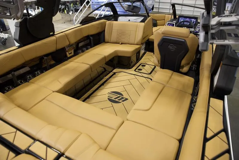 Slide: The Image of 2024 Malibu 23 LSV boat interior with tan leather seating and modern dashboard. - 4