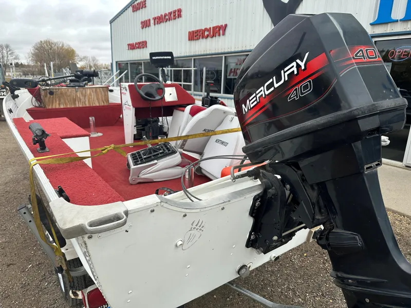 Slide: The Image of 1995 Northwood 1675 Fisherman boat with Mercury 40 outboard motor, parked outside dealership. - 12