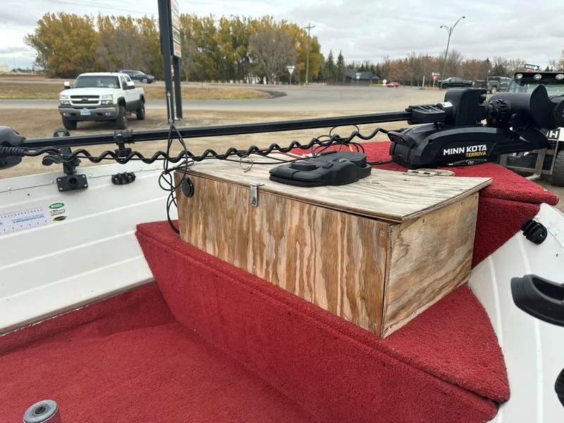 Slide: The Image of 1995 Northwood 1675 Fisherman boat interior with red carpet and Minn Kota trolling motor. - 2