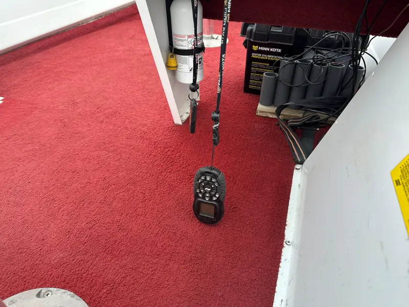 Slide: The Image of 1995 Northwood 1675 Fisherman interior with red carpet and marine equipment. - 5