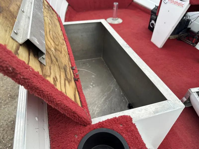 Slide: The Image of Open storage compartment on 1995 Northwood 1675 Fisherman boat with red carpet interior. - 6