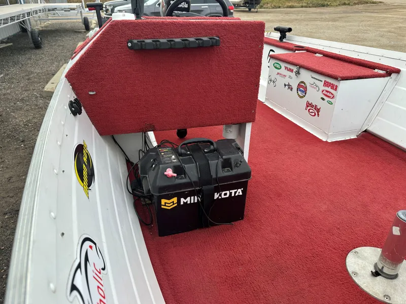 Slide: The Image of 1995 Northwood 1675 Fisherman boat interior with red carpet and Minn Kota battery. - 9