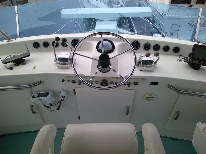 Slide: The Image of 1977 Tollycraft 37' Sedan helm with steering wheel and control panel. - 22