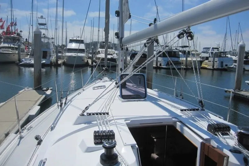 Slide: The Image of Sailboat Catalina 386, 2025 model, docked in a marina with clear skies. - 38