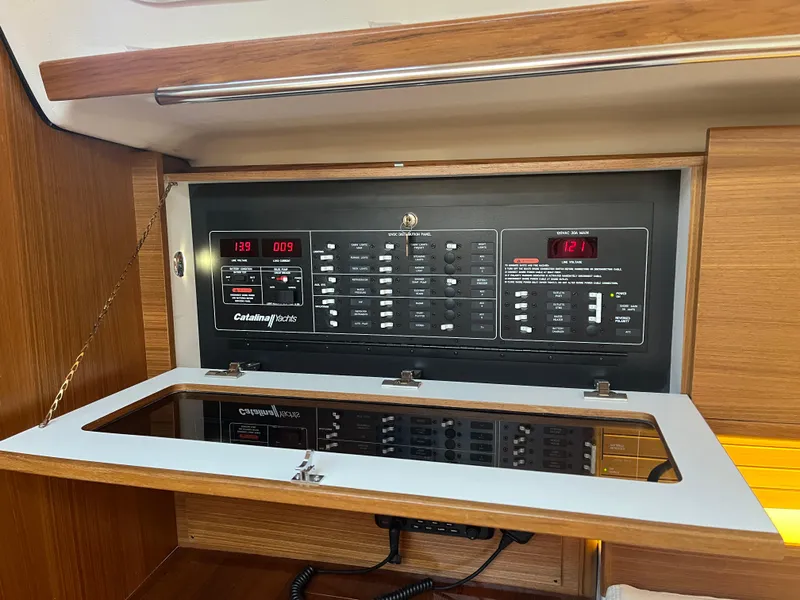 Slide: The Image of Electrical panel of 2025 Catalina 386 sailboat, featuring control switches and digital displays. - 18