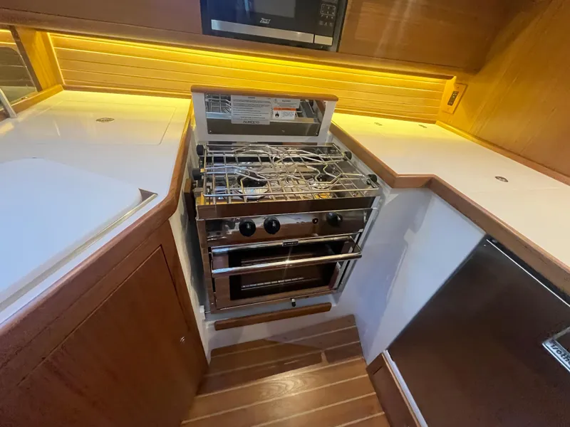 Slide: The Image of Modern kitchen in 2025 Catalina 386 yacht with stove and sleek countertops. - 20