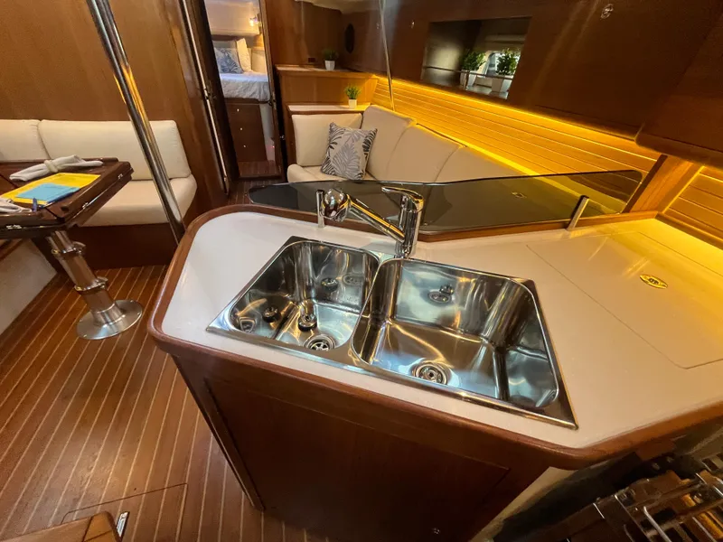 Slide: The Image of Luxurious Catalina 386 yacht interior with modern kitchen and cozy seating, 2025 model. - 22