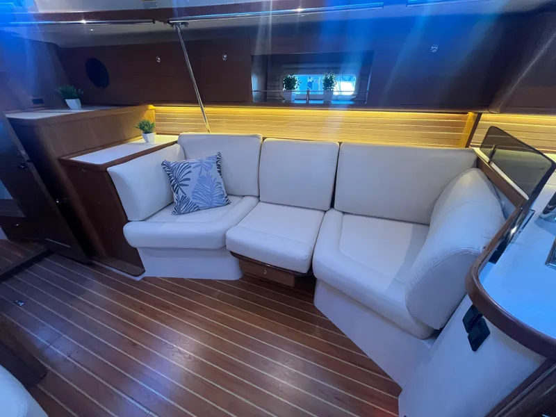 Slide: The Image of Luxurious interior of 2025 Catalina 386 yacht with white leather seating and wooden flooring. - 24