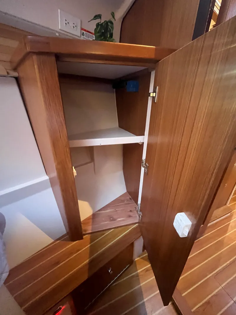 Slide: The Image of Open wooden cabinet inside 2025 Catalina 386 sailboat interior. - 27