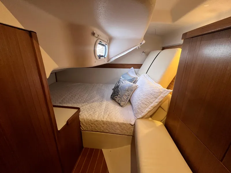 Slide: The Image of 2025 Catalina 386 yacht cabin with cozy bed and wooden interior. - 32