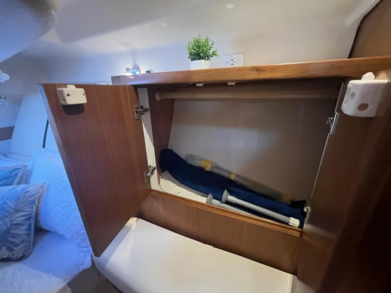 Slide: The Image of Open cabinet in 2025 Catalina 386 yacht interior with bedding and plant. - 33