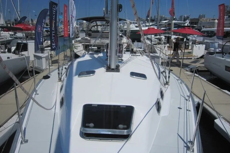 Slide: The Image of 2025 Catalina 386 sailboat docked at marina with flags and other boats. - 48